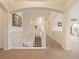 Bright hallway with arches, carpet flooring and a view to several rooms in the house at 1976 The Oaks Blvd, Kissimmee, FL 34746