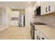 Bright and open kitchen with stainless steel appliances, granite counters, and tile flooring at 1976 The Oaks Blvd, Kissimmee, FL 34746