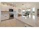 Modern kitchen featuring white cabinets, stainless steel appliances, and a large countertop island at 1976 The Oaks Blvd, Kissimmee, FL 34746