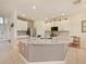 Spacious kitchen with white cabinetry, granite countertops and stainless steel appliances at 1976 The Oaks Blvd, Kissimmee, FL 34746