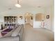 Bright living room featuring neutral carpet, vaulted ceilings, arched doorways, and built-in shelving at 1976 The Oaks Blvd, Kissimmee, FL 34746