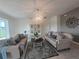 Inviting living room showcasing two sofas, neutral walls, and an elegant chandelier at 1976 The Oaks Blvd, Kissimmee, FL 34746