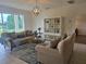 Bright living room showcasing modern furnishings, a decorative chandelier, and neutral décor at 1976 The Oaks Blvd, Kissimmee, FL 34746