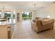 Open living room with tile floors, neutral furniture, and sliding glass doors to patio at 1976 The Oaks Blvd, Kissimmee, FL 34746