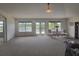 Spacious living room boasting a scenic lake view from the three windows and access to the lanai at 1976 The Oaks Blvd, Kissimmee, FL 34746