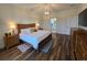 Spacious main bedroom featuring a hardwood floor, contemporary light fixture, and an ensuite bathroom at 1976 The Oaks Blvd, Kissimmee, FL 34746