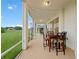 Spacious screened patio with tile flooring, string lights, and comfortable seating at 1976 The Oaks Blvd, Kissimmee, FL 34746