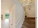 Carpeted staircase with white railing leads to the upper level of the home at 1976 The Oaks Blvd, Kissimmee, FL 34746