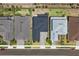 Overhead view of homes exhibiting manicured lawns, concrete driveways, and proximity to community streets at 2110 Old Hollow Ln, Clermont, FL 34715