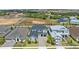 Aerial view of a home showcasing a well-kept lawn, complementary landscaping, and a spacious driveway at 2110 Old Hollow Ln, Clermont, FL 34715