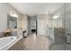 Spacious bathroom with glass shower, tub, double sinks and vanity at 2110 Old Hollow Ln, Clermont, FL 34715