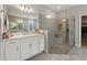 Bright bathroom with glass shower enclosure, double sinks and vanity at 2110 Old Hollow Ln, Clermont, FL 34715