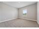 Bright bedroom features neutral paint, carpeted flooring, and a window with natural light at 2110 Old Hollow Ln, Clermont, FL 34715