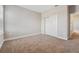 Bedroom with carpet flooring, neutral walls, window and access to closet at 2110 Old Hollow Ln, Clermont, FL 34715
