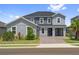 Attractive two-story home with a brick driveway, well-maintained lawn, and symmetrical window placement at 2110 Old Hollow Ln, Clermont, FL 34715