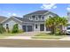 Beautiful two-story home with a three-car garage, brick driveway, and lush landscaping at 2110 Old Hollow Ln, Clermont, FL 34715