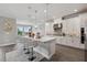 Bright, open kitchen with white cabinets, quartz countertops, and stainless steel appliances at 2110 Old Hollow Ln, Clermont, FL 34715