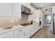 Gas range and stainless hood featured in this modern home kitchen with stylish backsplash at 2110 Old Hollow Ln, Clermont, FL 34715