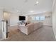 Carpeted upstairs living area with large sectional sofa and natural light at 2110 Old Hollow Ln, Clermont, FL 34715