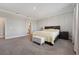 Large main bedroom boasts neutral colors, a king bed, and an en-suite bathroom at 2110 Old Hollow Ln, Clermont, FL 34715