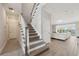 Carpeted staircase leads to open living area with great view through large windows at 2110 Old Hollow Ln, Clermont, FL 34715