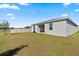Spacious backyard featuring lush lawn and a covered patio area at 2156 Merrybells Dr, Kissimmee, FL 34746