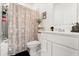 Well-lit bathroom with shower, white cabinets and marble countertop at 2156 Merrybells Dr, Kissimmee, FL 34746