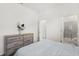 Serene bedroom featuring a dresser and access to a bathroom with a tiled shower at 2156 Merrybells Dr, Kissimmee, FL 34746