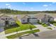 Overhead view of a property showing the front yard landscaping and lake backdrop at 2156 Merrybells Dr, Kissimmee, FL 34746