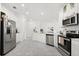 Spacious kitchen with stainless steel appliances, white cabinetry, and large countertops at 2156 Merrybells Dr, Kissimmee, FL 34746