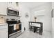 Bright kitchen with stainless steel appliances and a cozy breakfast nook at 2156 Merrybells Dr, Kissimmee, FL 34746