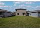Large backyard with lush green grass, offering ample space for recreation and relaxation at 2189 Teneroc Trl, Lakeland, FL 33801