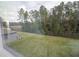View of the expansive backyard with green grass and partial fence at 2189 Teneroc Trl, Lakeland, FL 33801