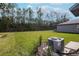 Spacious backyard with lush green grass, privacy fence and mature trees creating a peaceful setting at 2189 Teneroc Trl, Lakeland, FL 33801