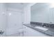 Well-lit bathroom features a granite countertop, white cabinets, and a shower over the tub at 2189 Teneroc Trl, Lakeland, FL 33801