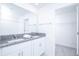 Bright bathroom featuring a double sink vanity with a granite countertop and a large mirror at 2189 Teneroc Trl, Lakeland, FL 33801