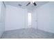 Neutral bedroom with carpet, white walls, a window, and a white door at 2189 Teneroc Trl, Lakeland, FL 33801