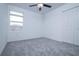 Neutral bedroom with carpet, white walls, a window, and double door closet at 2189 Teneroc Trl, Lakeland, FL 33801