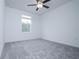 Bright bedroom with neutral carpet and ceiling fan, providing comfort and style at 2189 Teneroc Trl, Lakeland, FL 33801