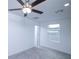 Bright, carpeted bedroom featuring a ceiling fan, window, and neutral tones, creating a relaxing atmosphere at 2189 Teneroc Trl, Lakeland, FL 33801