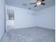 Carpeted bedroom with ceiling fan, neutral walls, and ample space at 2189 Teneroc Trl, Lakeland, FL 33801