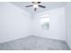 Bright bedroom with neutral carpet and ceiling fan, offering comfort and style at 2189 Teneroc Trl, Lakeland, FL 33801