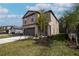 Lovely two-story home with a spacious driveway, a two-car garage and fresh landscaping at 2189 Teneroc Trl, Lakeland, FL 33801