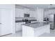 Modern kitchen with granite counters, stainless steel appliances, white cabinetry, and island at 2189 Teneroc Trl, Lakeland, FL 33801