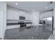 Well-lit kitchen featuring granite countertops, stainless steel appliances, and white cabinets at 2189 Teneroc Trl, Lakeland, FL 33801