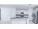 Bright kitchen with granite counters, stainless steel appliances, white cabinets and large island at 2189 Teneroc Trl, Lakeland, FL 33801