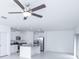 Open floorplan with white kitchen featuring island, stainless steel appliances and tile floor at 2189 Teneroc Trl, Lakeland, FL 33801