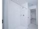 Modern shower featuring horizontal white tiling, a shower head, and a sliding glass door entrance to the bathroom at 2189 Teneroc Trl, Lakeland, FL 33801