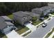 A street view of beige two-story homes with landscaped lawns and paved driveways on a sunny day at 2189 Teneroc Trl, Lakeland, FL 33801