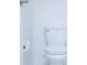Close-up of a standard white toilet with a visible toilet paper holder, set against a plain white wall at 2189 Teneroc Trl, Lakeland, FL 33801